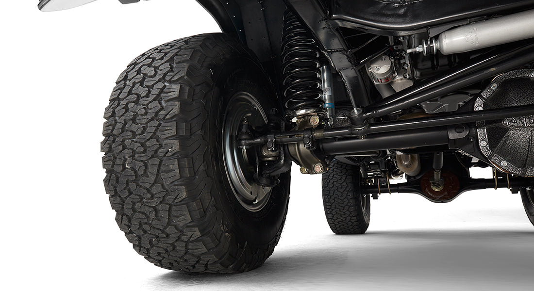 Close-up of front tire and suspension components of Classic Ford Bronco