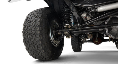 Close-up of front tire and suspension components of Classic Ford Bronco