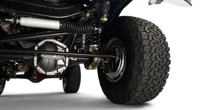 Detailed view of wheel hub, tire and suspension assembly under Classic Ford Bronco