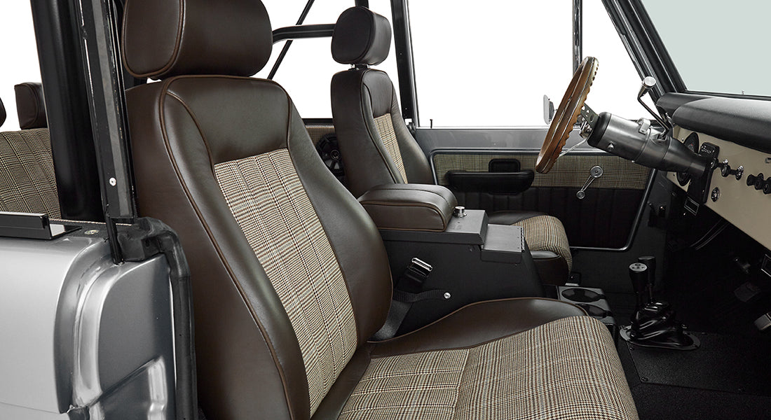 Front seats with brown leather and plaid upholstery in Classic Ford Bronco interior