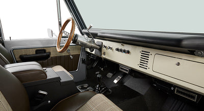 Classic Ford Bronco interior passenger side with seat, door, center console, and dashboard.