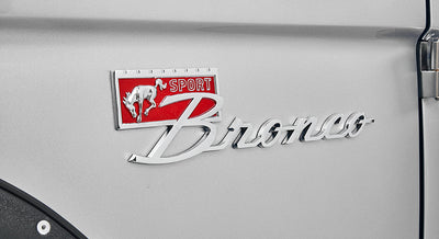 Close-up of Silver Classic Ford Bronco Sport emblem on vehicle side.