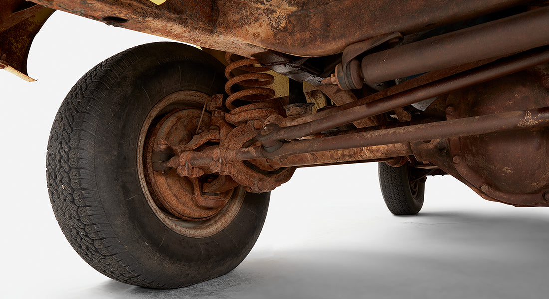 Close-up of rusted suspension and wheel of Classic Ford Bronco