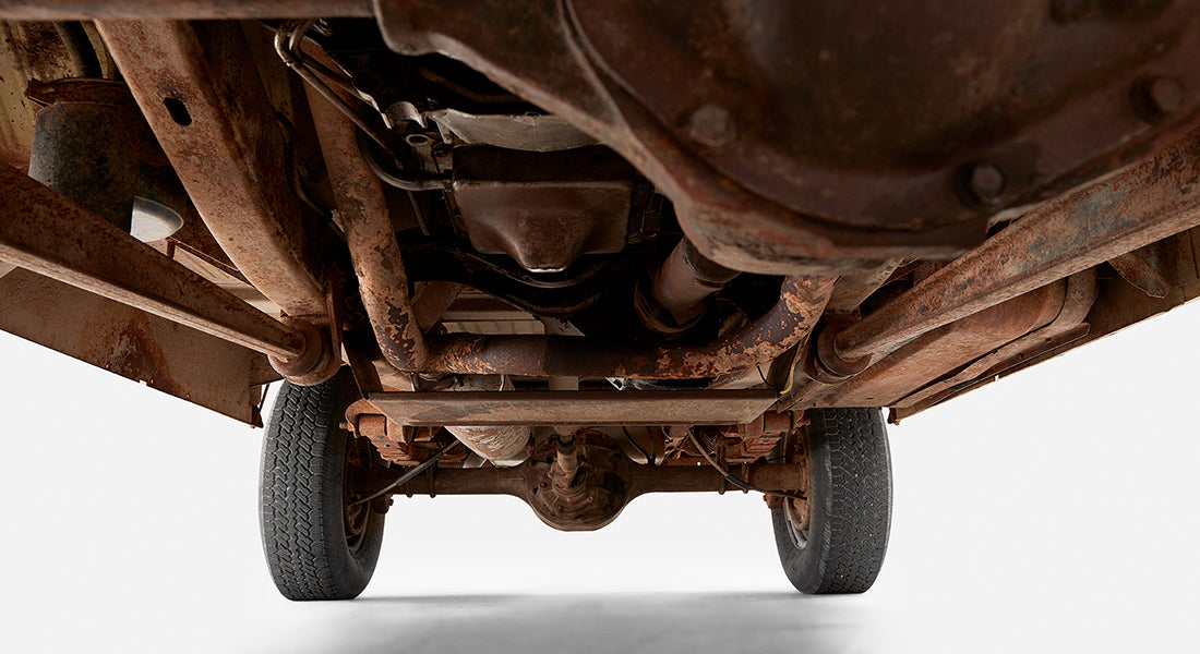 Rusty undercarriage view showing rear axle and exhaust of Classic Ford Bronco