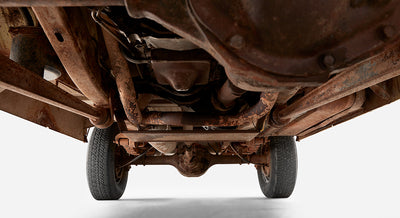 Rusty undercarriage view showing rear axle and exhaust of Classic Ford Bronco