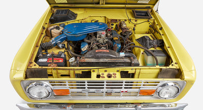 Front view of Classic Ford Bronco with hood open showing radiator and engine components