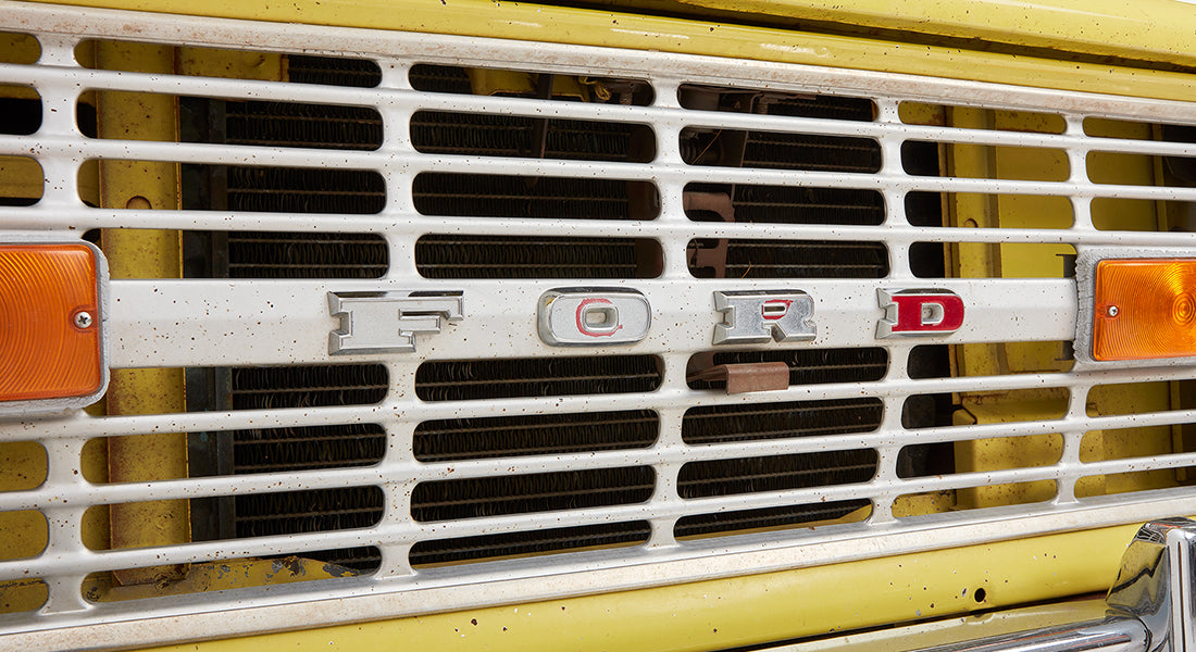 Close-up of front grille of Classic Ford Bronco with FORD lettering and yellow body