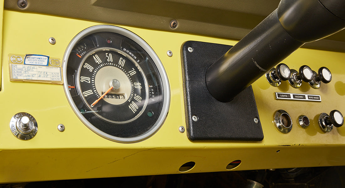 Close-up of speedometer and dashboard controls inside yellow Classic Ford Bronco