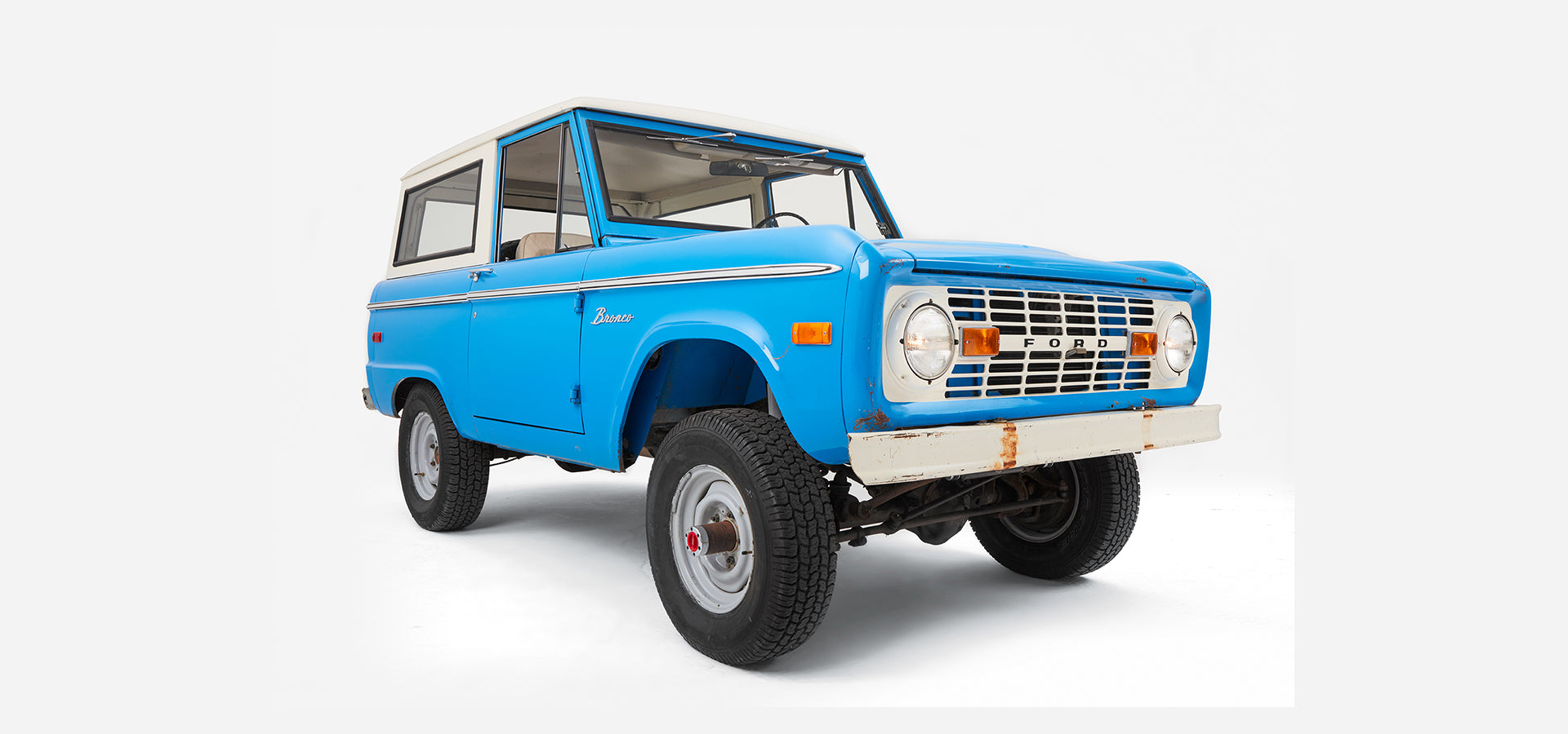 Classic Ford Bronco blue two-door vehicle facing left, showing full body and tires