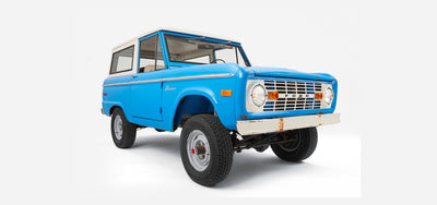 Classic Ford Bronco blue two-door vehicle facing left, showing full body and tires