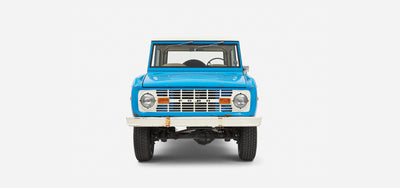 Front view of Classic Ford Bronco showing headlights, grill, and white bumper