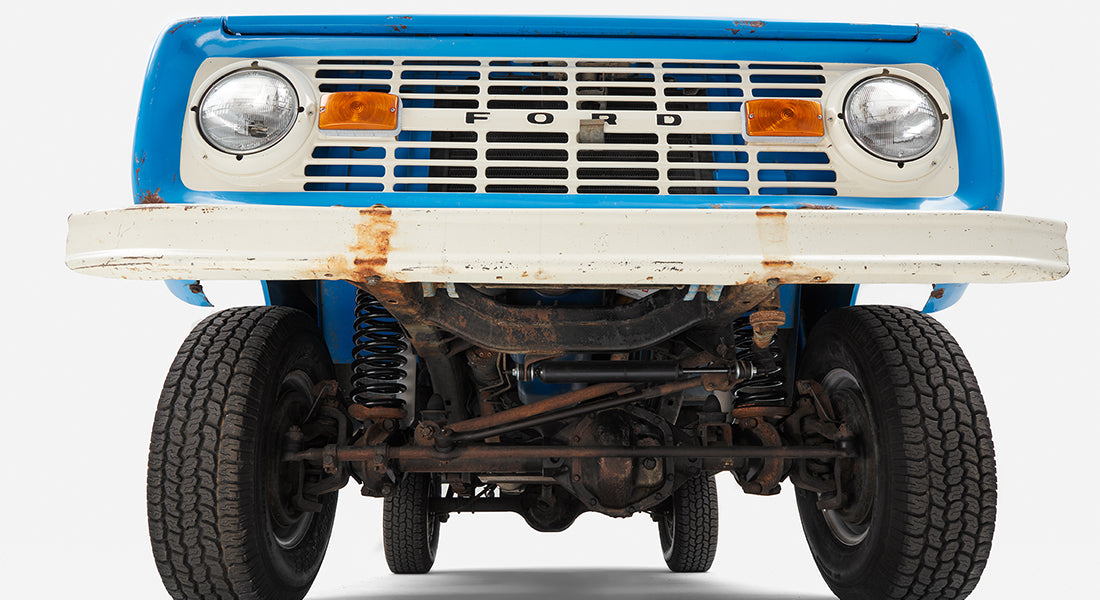 Underneath front view of Classic Ford Bronco showing suspension and tires