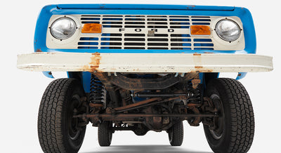 Underneath front view of Classic Ford Bronco showing suspension and tires