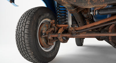 Close-up of the front left suspension and wheel of Classic Ford Bronco