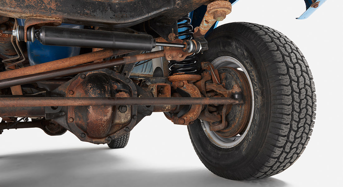 Close-up of the front right suspension and wheel of Classic Ford Bronco