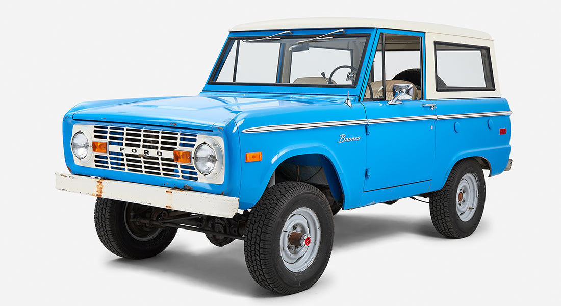 Classic Ford Bronco in blue with white roof viewed from front right side
