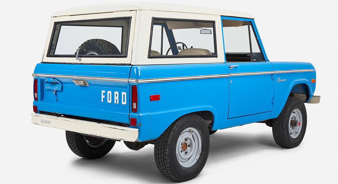 Classic Ford Bronco in blue with white roof viewed from rear left side