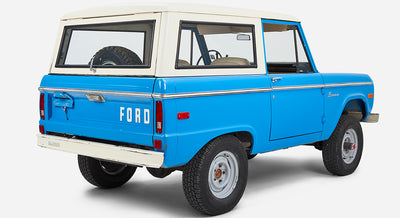 Classic Ford Bronco in blue with white roof viewed from rear left side