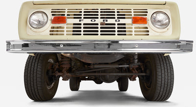 Close-up front view of Classic Ford Bronco grille and bumper showing headlights and orange turn signals