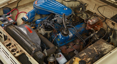 Close-up of Classic Ford Bronco engine bay showing air filter, radiator, and wiring