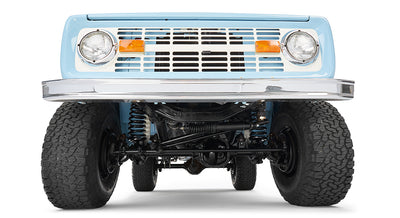 Underside view of classic Ford Bronco baby blue showing suspension and front axle.