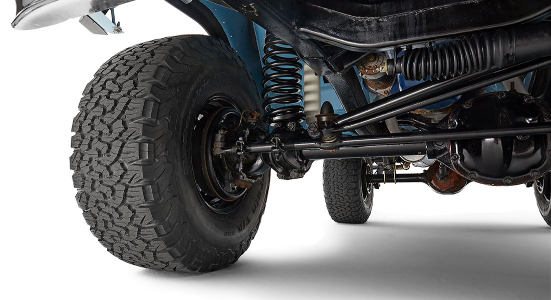 Side angle view of tire and suspension system under a Classic Ford Bronco