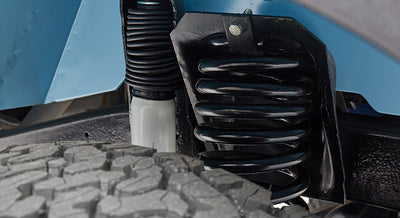 Close-up of suspension coil spring and off-road tire on Classic Ford Bronco