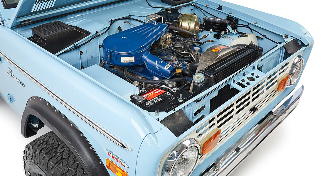 Classic Ford Bronco baby blue hood open showing engine and front grille