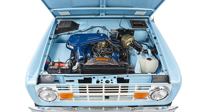 Front view of baby blue Classic Ford Bronco engine and radiator with open hood