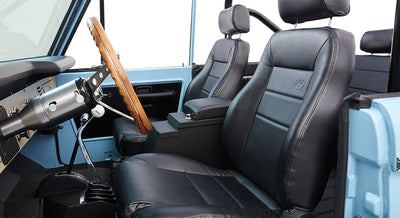 Front leather bucket seats with armrest and steering wheel inside Classic Ford Bronco