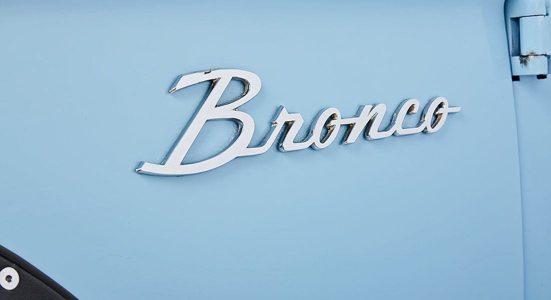 Chrome Bronco emblem on baby blue vehicle body