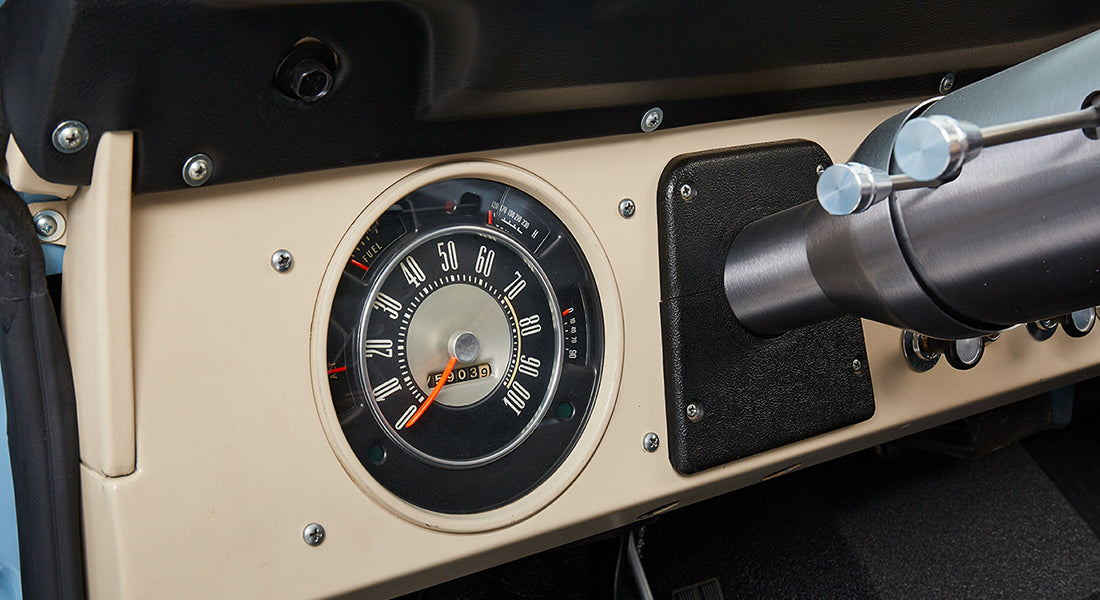 Classic Ford Bronco dashboard speedometer dial showing mileage and part of steering column.