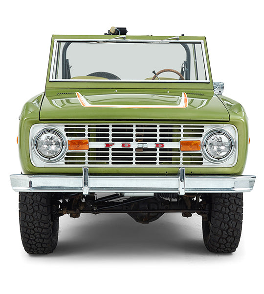 Front view of green Classic Ford Bronco with headlights and Ford grille visible.