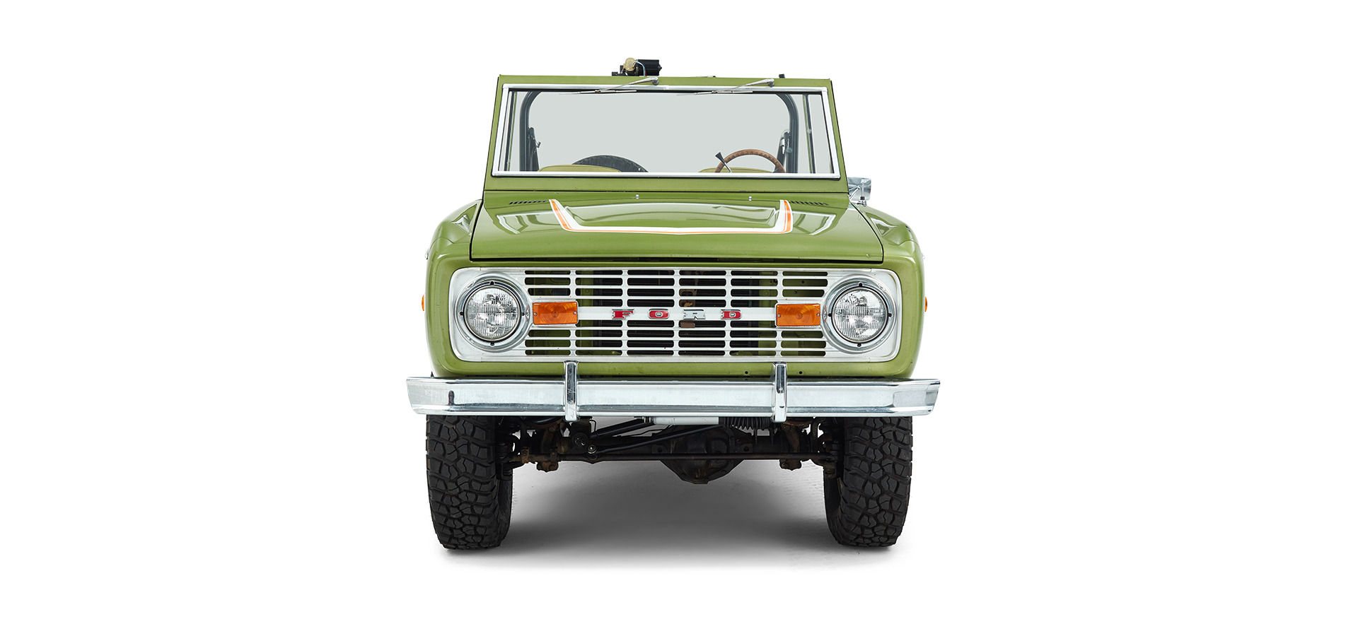 Front view of green and white Classic Ford Bronco with two round headlights and no roof.