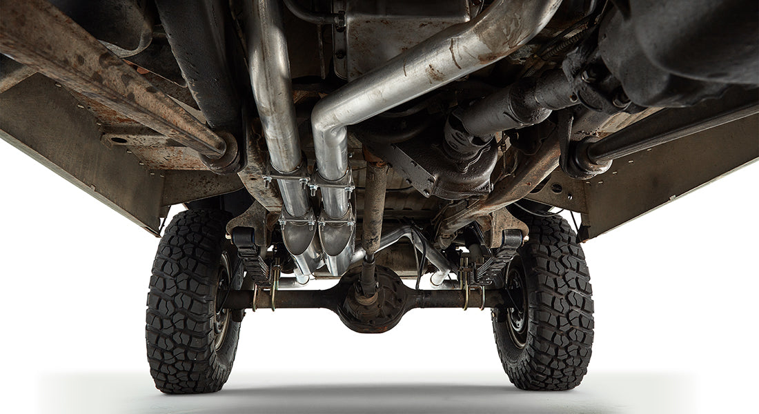 Underneath view of the Classic Ford Bronco showing exhaust pipes and rear suspension