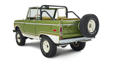 Rear view of a green Classic Ford Bronco with spare tire mounted on tailgate
