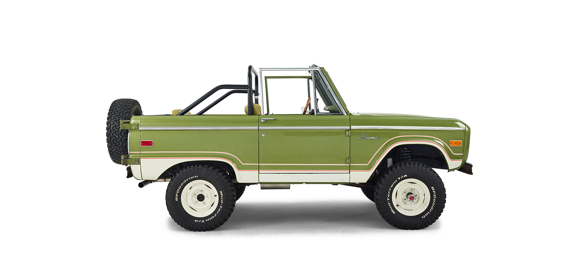 Side profile of a green and white Classic Ford Bronco with off-road tires and roll bar.