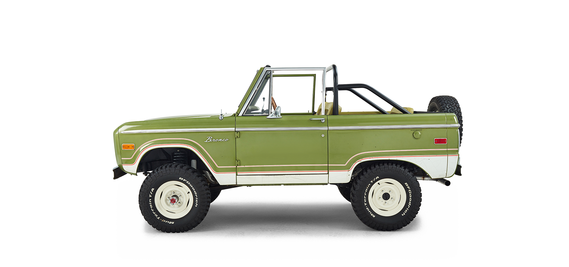 Side profile of a green and white Classic Ford Bronco with no roof and off-road tires.