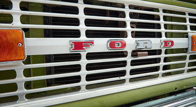 Close-up of the front grille of a Classic Ford Bronco with the red FORD letters