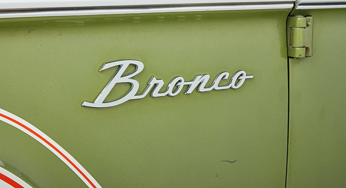 Side emblem badge on the fender of a Classic Ford Bronco reading ‘Bronco’