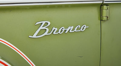 Side emblem badge on the fender of a Classic Ford Bronco reading ‘Bronco’