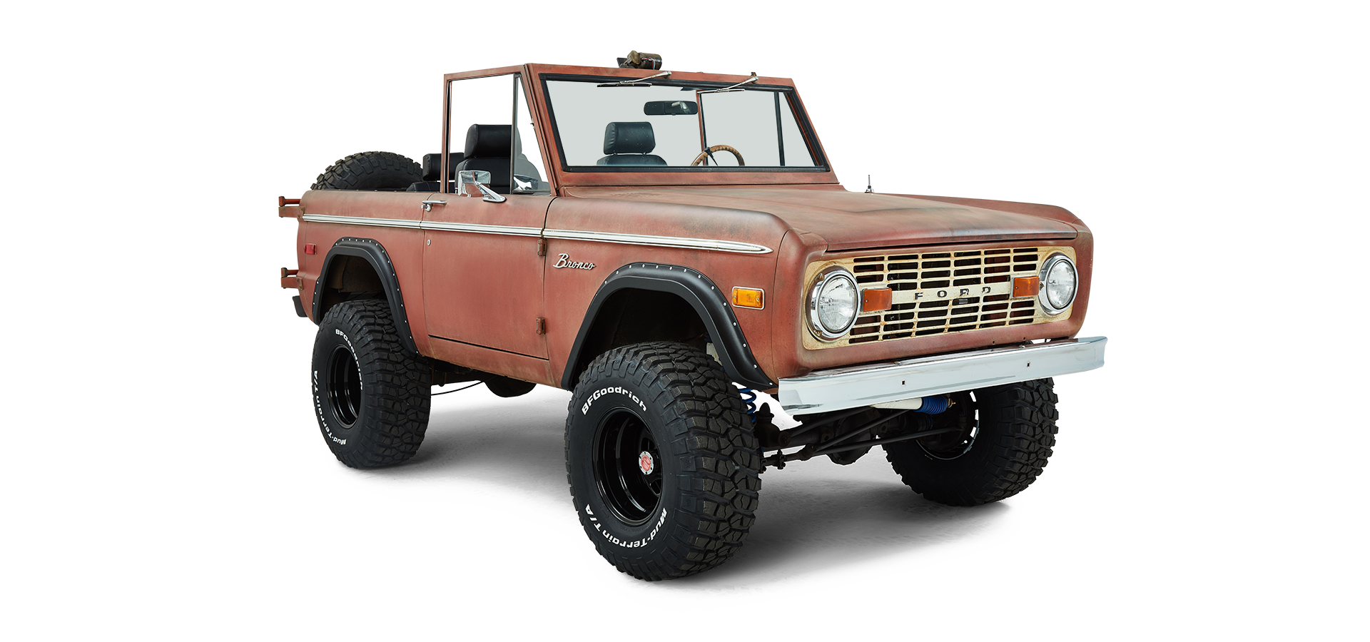 Front driver angle view of a red Classic Ford Bronco with patina finish and lifted suspension