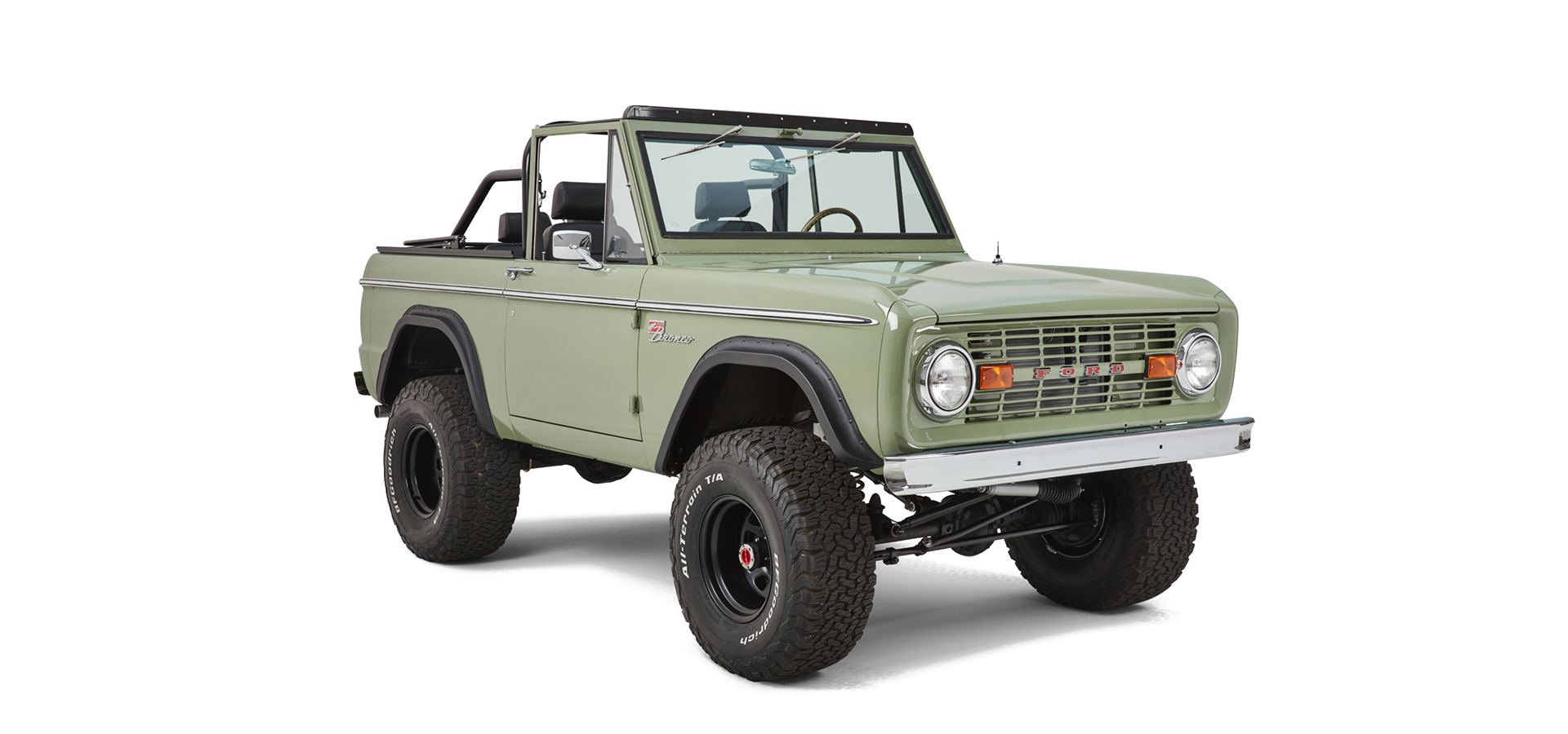 Three-quarter front view of Classic Ford Bronco with green paint and off-road tires