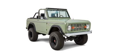 Three-quarter front view of Classic Ford Bronco with green paint and off-road tires