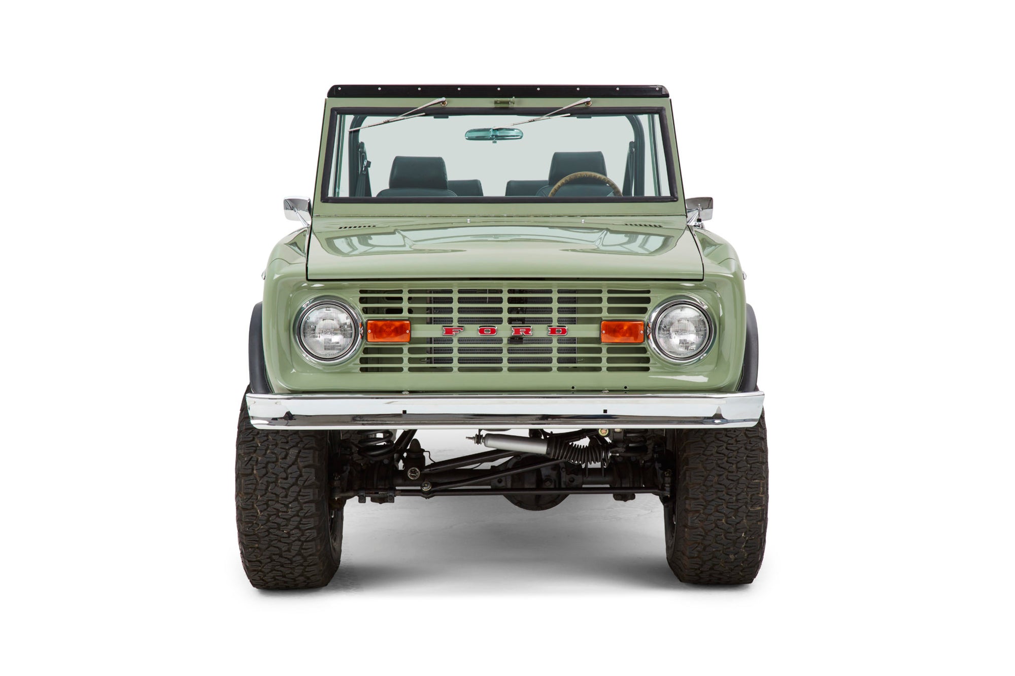 Classic Ford Bronco front view in green with chrome bumper and round headlights