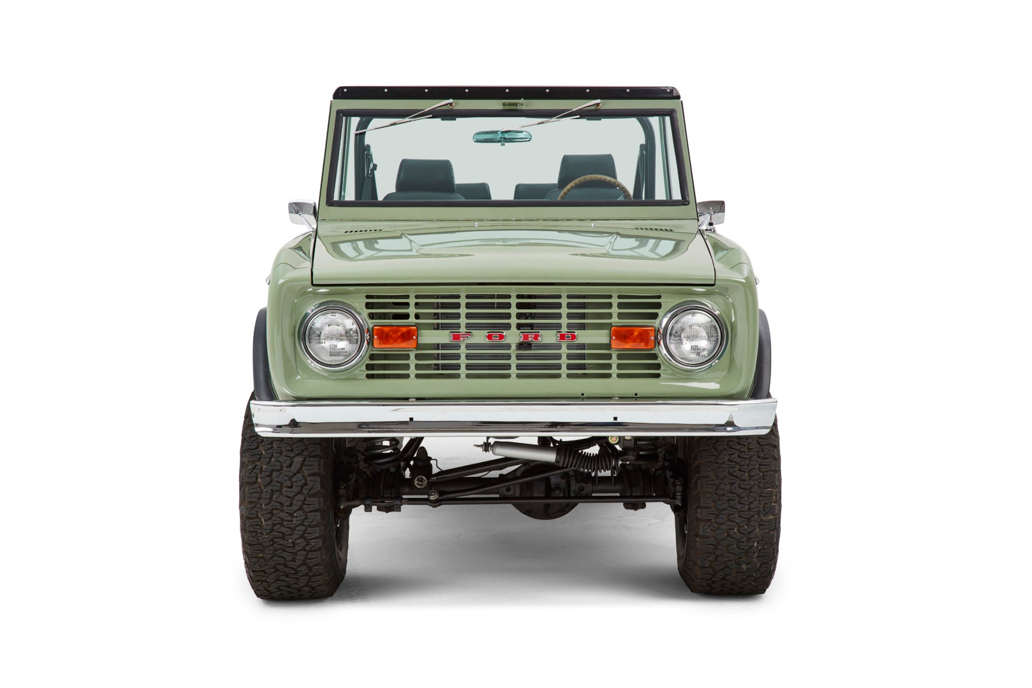 Classic Ford Bronco front view in green with chrome bumper and round headlights