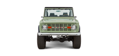 Classic Ford Bronco front view in green with chrome bumper and round headlights