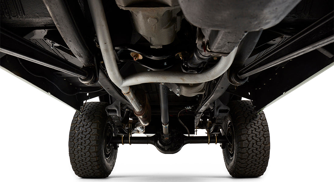Underside of Classic Ford Bronco showing exhaust system, frame, and rear axle