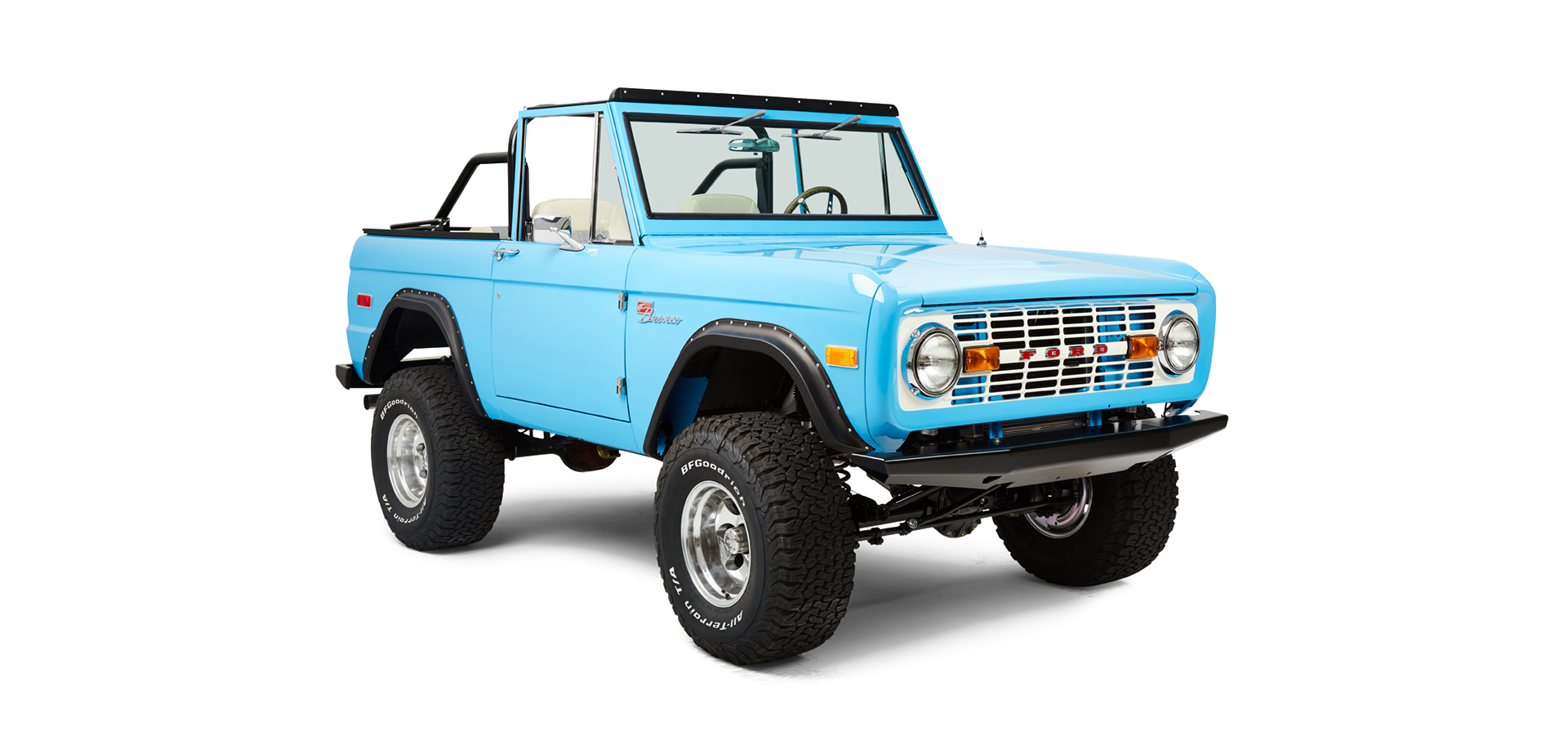Front three-quarter view of bright blue Classic Ford Bronco facing slightly left with lifted suspension.