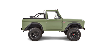 Side profile of Classic Ford Bronco with green body, black wheels, and roll bar